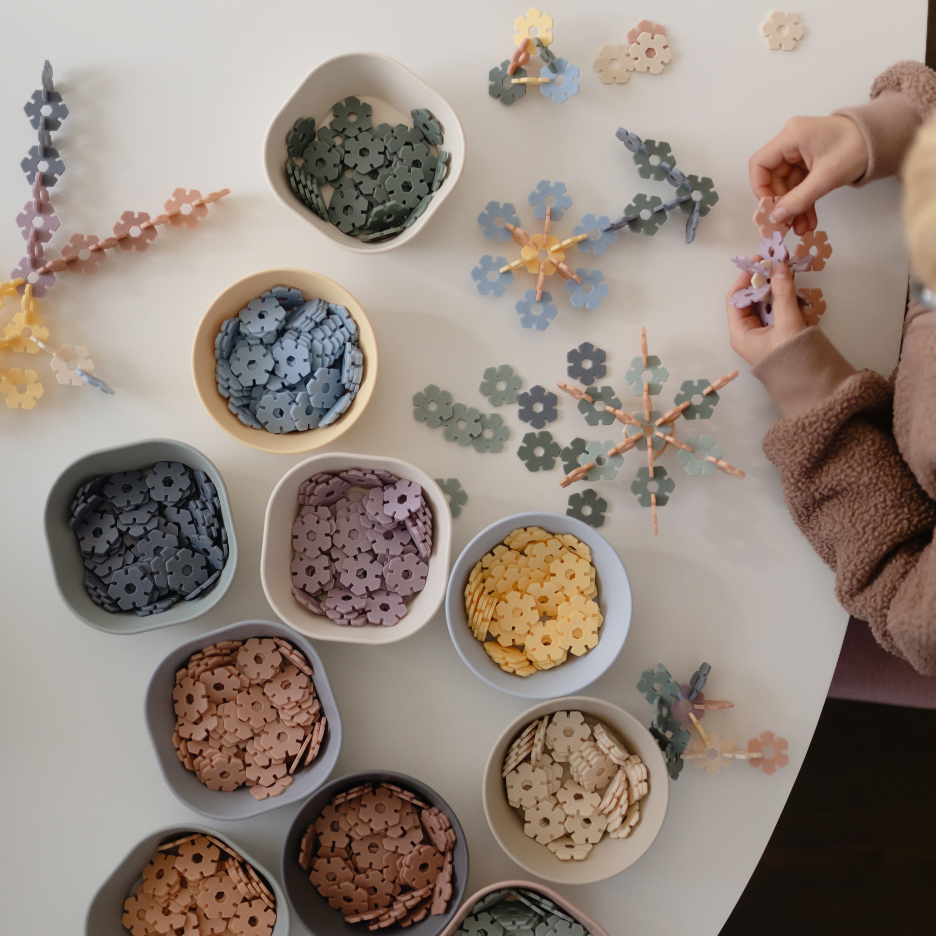 Enfant créant des fleurs avec les pièces pastel Hex Connect