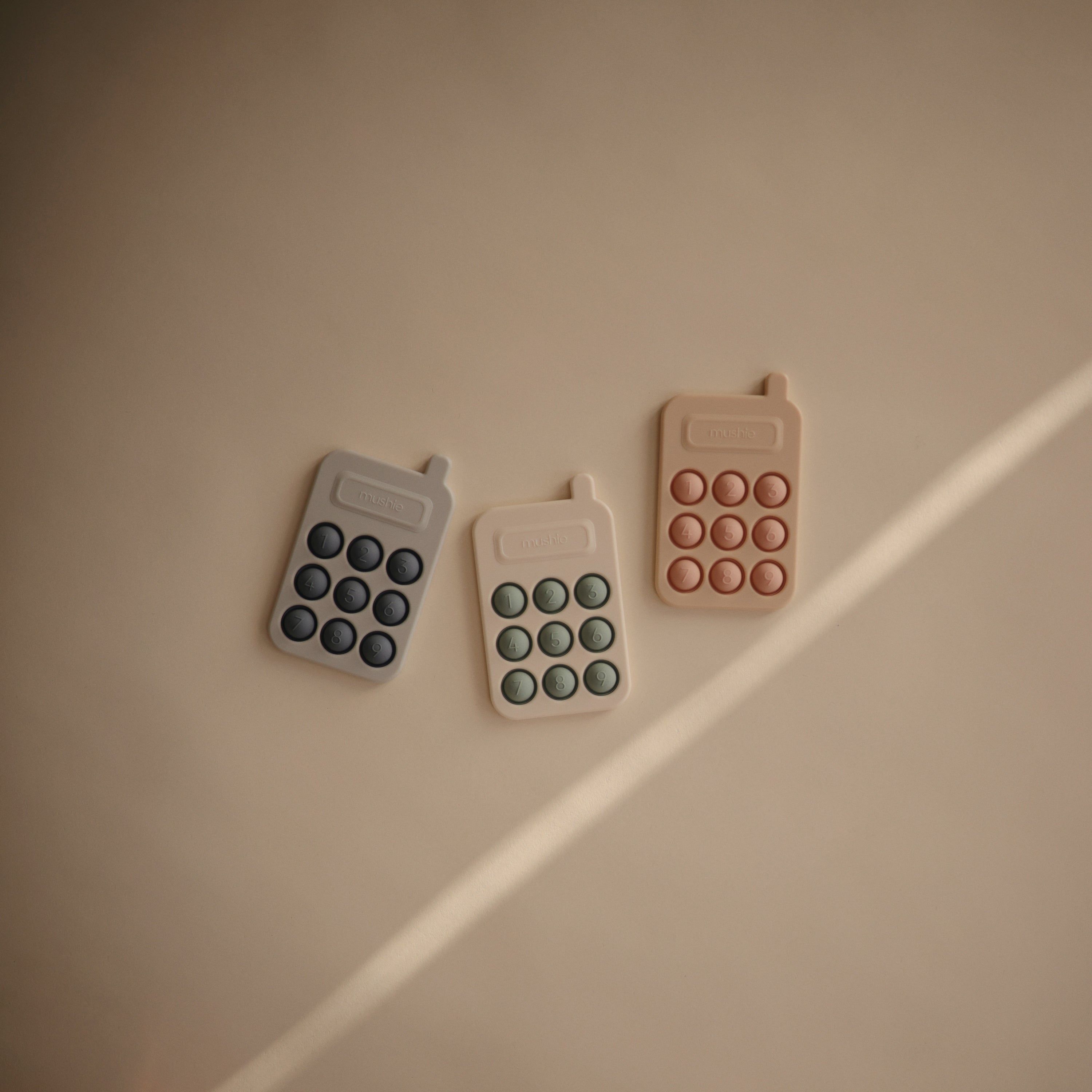 Téléphones à presser Mushie en trois coloris